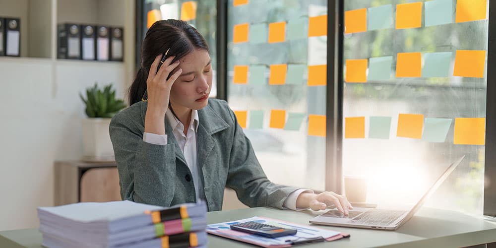 Frustrated business owner reviewing Google Ads management agency performance on laptop